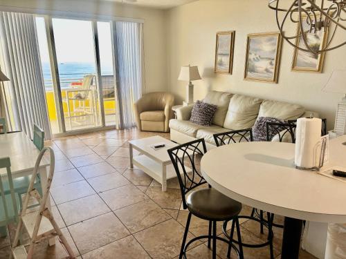 a living room with a couch and a table at Ocean Walk Resort - Dramatic Ocean Front View in Daytona Beach