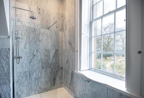 a bathroom with a shower and a window at Wren Place Hall in Barnsley
