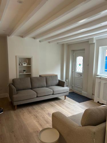 a living room with a couch and a window at 15B Church Street, Bingham, Nottingham, Nottinghamshire, NG13 8AL in Bingham