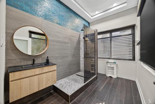 a bathroom with a shower and a sink and a mirror at Casa Lotus in San Juan