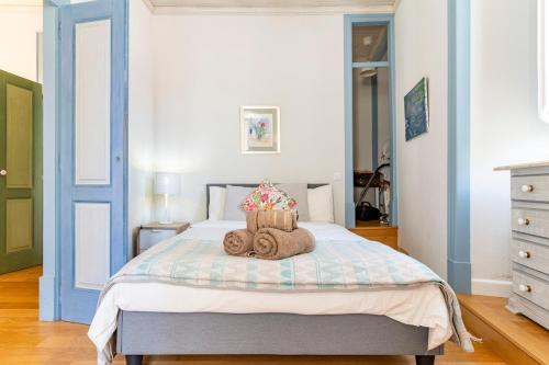 a bedroom with a bed with towels on it at Casa Oliveira in Lagos