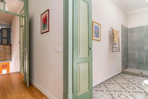a bathroom with a green door and a sink at Casa Oliveira in Lagos