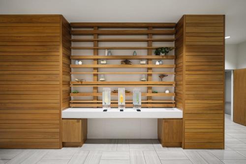 a room with wooden walls and shelves with vases at EVEN Hotel Atlanta - Cobb Galleria by IHG in Atlanta