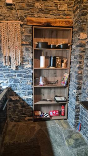 a shelf in a kitchen with some pots and pans at Black Rock Agria in Agria