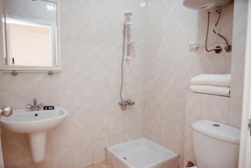 a bathroom with a toilet and a sink at Smouha Hotel in Alexandria