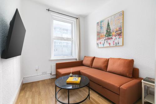 a living room with a couch and a table at Camden Central 4-Bedroom Flat -12 Guests in London