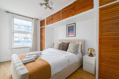 a bedroom with a large bed and a window at Camden Central 4-Bedroom Flat -12 Guests in London