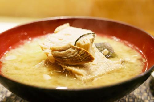 Eine Schüssel Suppe mit einem Löffel. in der Unterkunft Villa FUN Kawana in Ito