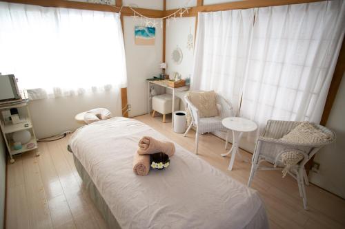 a bedroom with a teddy bear sitting on a bed at Family Stay & Relaxation -Tokyo East- in Tokyo