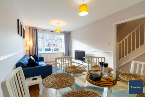 a living room with a glass table and chairs at Camberley Spacious and Comfy 3 Bedroom Home, Next to Frimley Hospital with Parking in Frimley