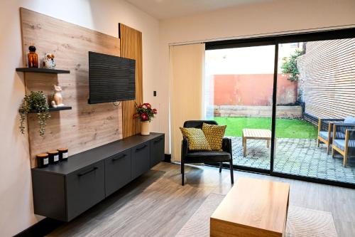 a living room with a tv on a wall at Laurie Grove in London