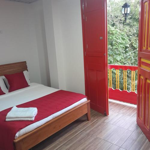 a bedroom with a bed and a large window at La Casa De Mi Tatis in Salento