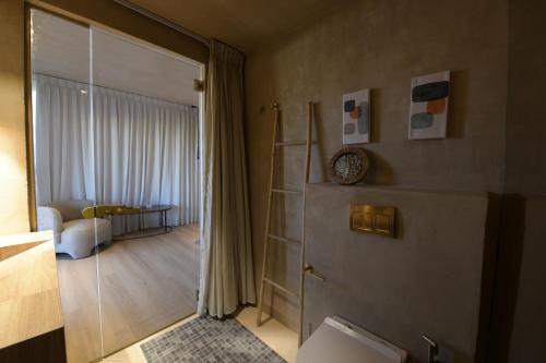 a bathroom with a door open to a room at Kohav Sea View Penthouse in Eilat