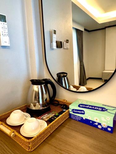 a table with a tray with dishes and a mirror at Black Pantera House in Patong Beach