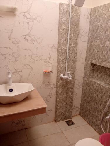 a bathroom with a sink and a shower at Bahria town karachi Volka Guest House in Karachi