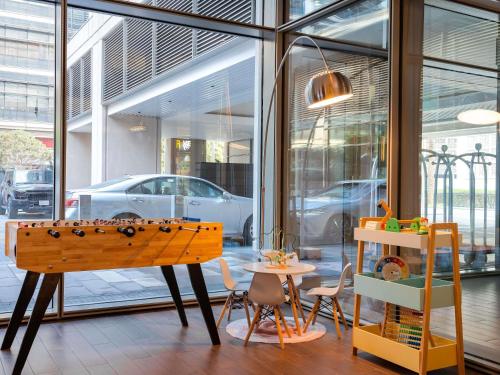 a room with a table and chairs and a window at ibis Dubai One Central in Dubai