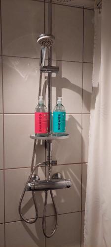 two bottles on a shelf in a bathroom at View apartment in Tromsø - northern lights, mountains, quiet in Tromsø