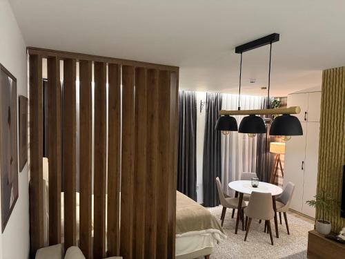 a bedroom with a bed and a table and chairs at GENCIAN RESORT in Kopaonik