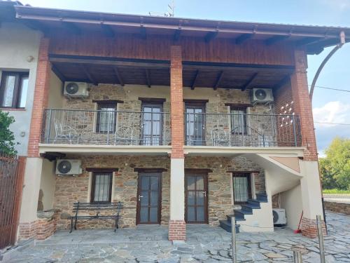 a building with a balcony on the side of it at Affittacamere il Gallo Panoramico - Alpine Trekking Stay in Donato