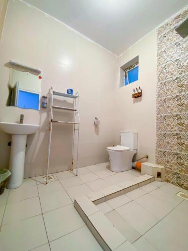 a bathroom with a toilet and a sink at Bella luxury homes in Mombasa