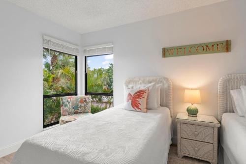 a bedroom with a bed and a window at Blind Pass #E209 in Sanibel
