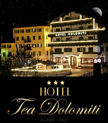 a sign for a hotel la dolomites at night at Hotel TEA DOLOMITI - Lago di Alleghe - Monte Civetta in Alleghe