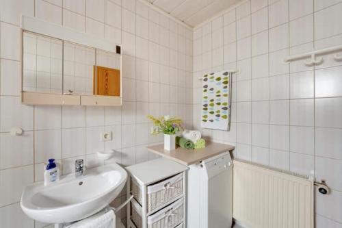 a white bathroom with a sink and a white refrigerator at Ferienwohnung PfalzRide in Annweiler am Trifels