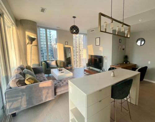 a living room with a couch and a table at Stunning suite in downtown perfect for businesses trips and small families in Toronto