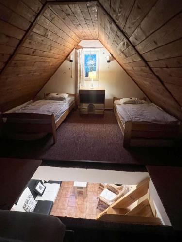 an overhead view of a attic bedroom with two beds at Taneček - malý apartmán u rodinného domu in Stvolínky