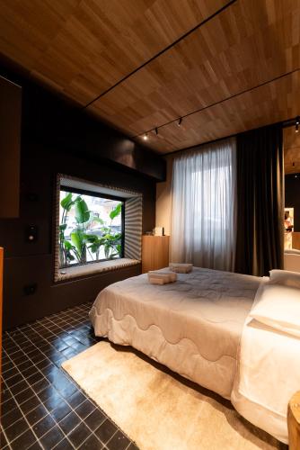 a bedroom with a large bed and a window at B&B Flow in San Benedetto del Tronto
