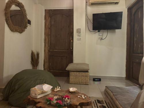 a living room with a couch and a table with flowers at Fresco in Dahab