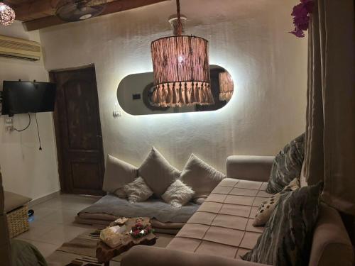 a living room with a couch and a chandelier at Fresco in Dahab