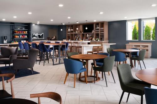 a restaurant with tables and chairs and a bar at EVEN Hotel Portland - Beaverton by IHG in Beaverton