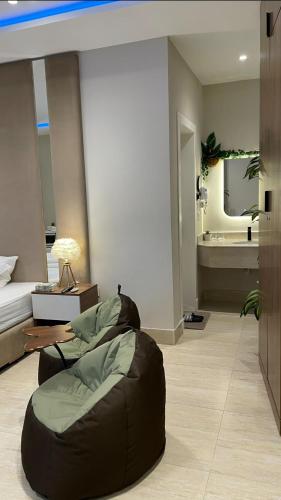 a living room with a bed and a bean bag chair at Mfj Marbella Stay دخول ذاتي بموقف خاص وإطلالة مسبح in Al Khobar