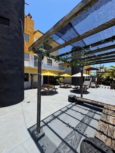 een terras met een serre, voorzien van een tafel en stoelen bij Hostel Farol in Pontal do Paraná