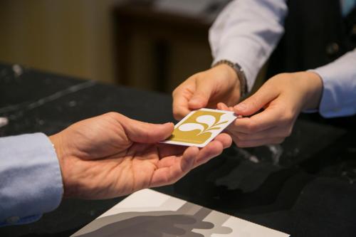 two people holding a cell phone in their hands at Hotel Nikko Huis Ten Bosch in Sasebo