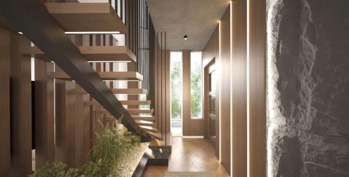 een hal met houten trap in een huis bij Montéa Villa in Brezovicë