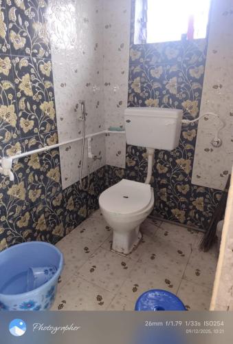 a bathroom with a toilet and a tub in it at Omkar Homestay Adgaon Beach Sea View Next to Diveagar 2 in Adgaon
