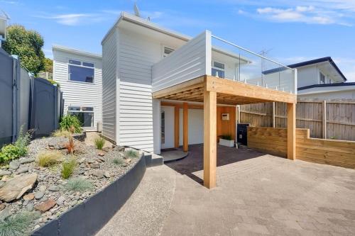 a white house with a glass roof at Luxury Town house with fabulous views in Hamilton