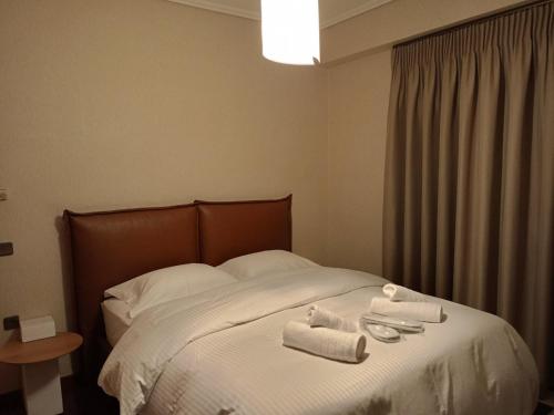 a bedroom with a bed with two towels on it at Village House by nature in Karkaloú