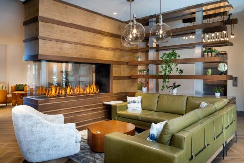 a living room with a couch and a fireplace at EVEN Hotel Bozeman Yellowstone Intl Arpt by IHG in Belgrade