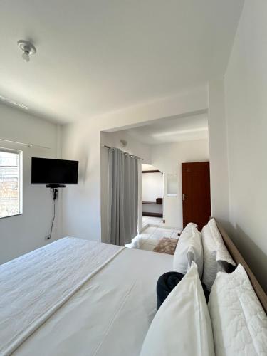 En eller flere senge i et værelse på Pousada Sol & Mar