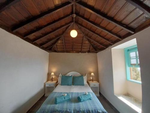 a bedroom with a bed with two night stands at El Olivo de Mazo 2 in Mazo