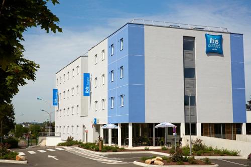 a large white building with a blue sign on it at Ibis Budget Chalon Sur Saone Nord in Chalon-sur-Saône