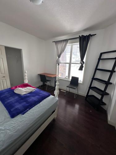 a bedroom with a bed and a ladder and a desk at Sam Estates in Calgary