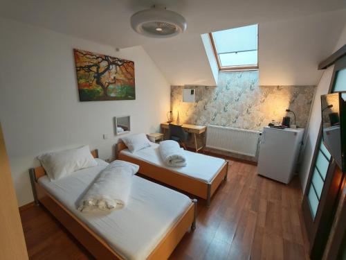 a small room with two beds and a window at Sleep&Go Airport Transit Rooms Cluj-Napoca in Cluj-Napoca