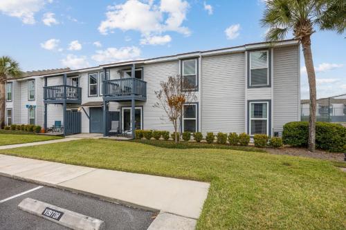 an apartment building with balconies and a driveway at Chill by The Shores - Pet Friendly - Fernandina Beach in Fernandina Beach