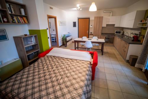 a living room with a bed and a kitchen at Flat with terrace close to Forum and Milanofiori Metro in Assago