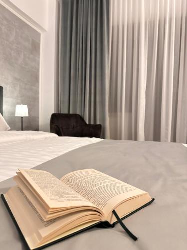 an open book sitting on top of a bed at No107 Predeal in Predeal