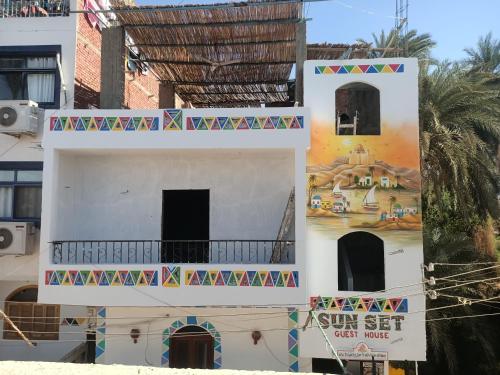 a building with a mural on the side of it at sunset guest house in Aswan